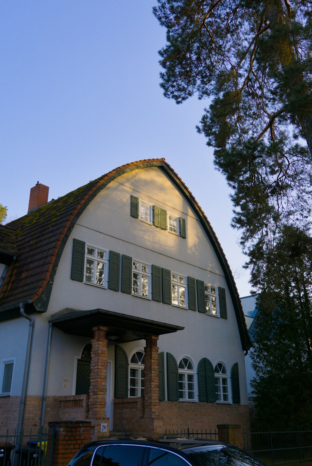 About a-large-house-with-green-shutters-and-a-curved-roof-zpsayfajr30