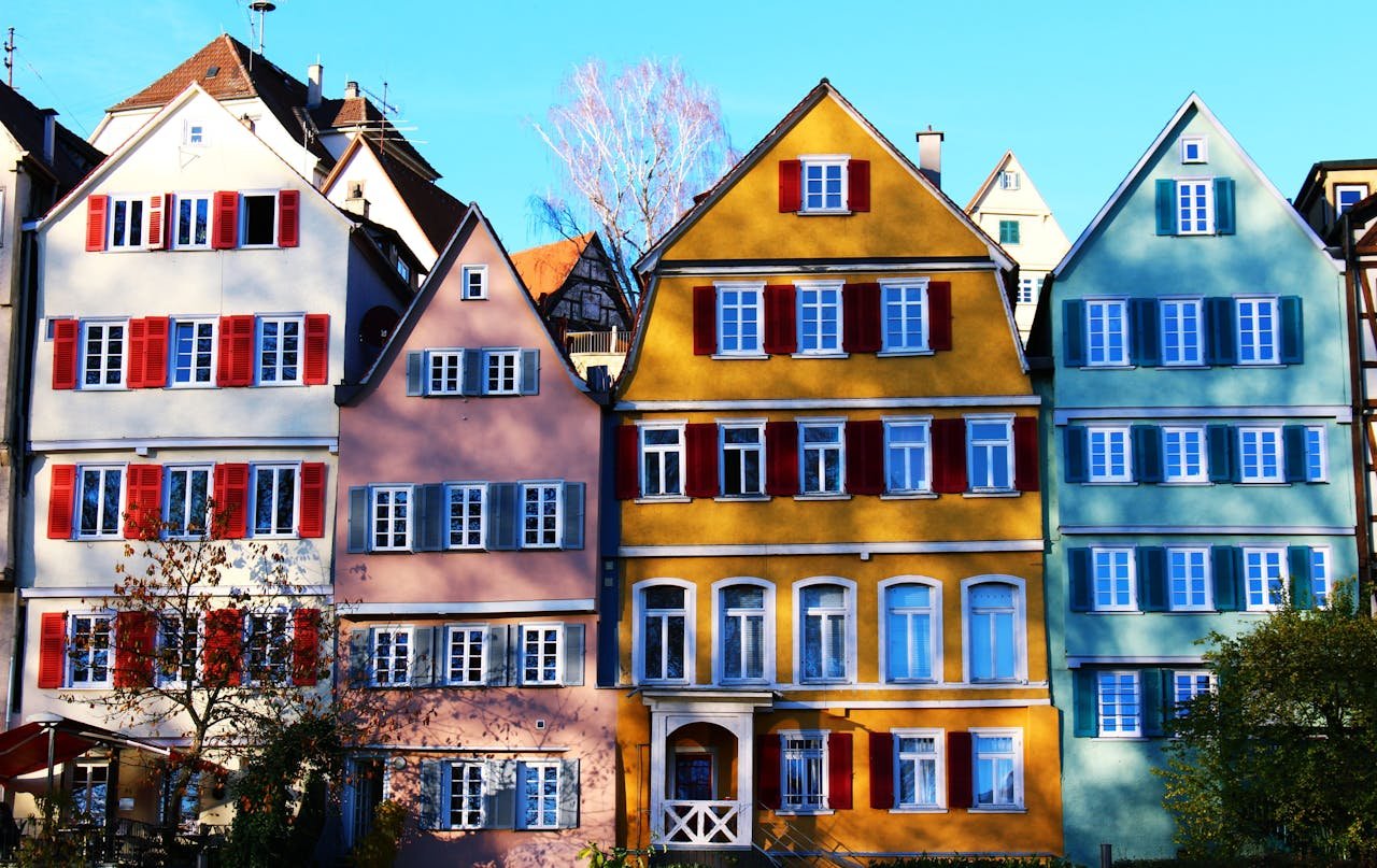 Services Vibrant facades of traditional houses in Tübingens historic center, under a clear daytime sky.
